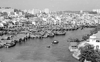 Singapore River with bumboats and the early Boat Quay skyline, 1960s — black and white photograph.